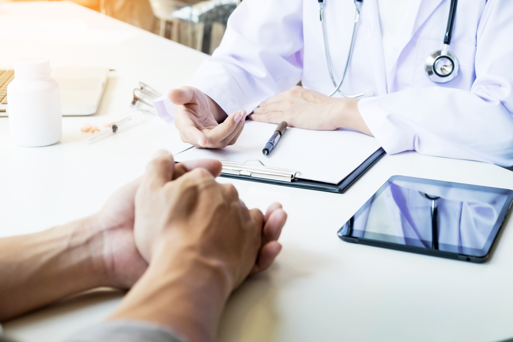 Hands of patient and doctor during consultation
