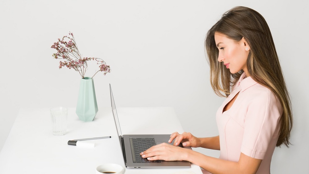 A Woman working in her home office after finding tips for staying busy