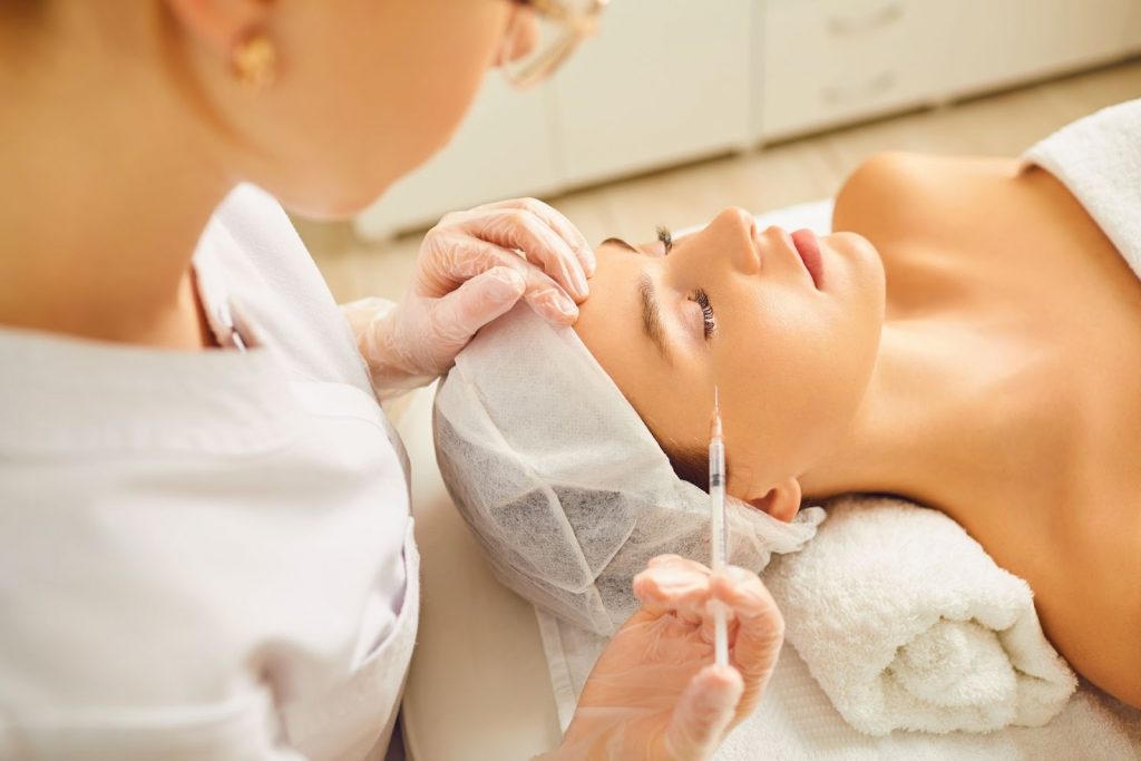 A woman receives Botox injections