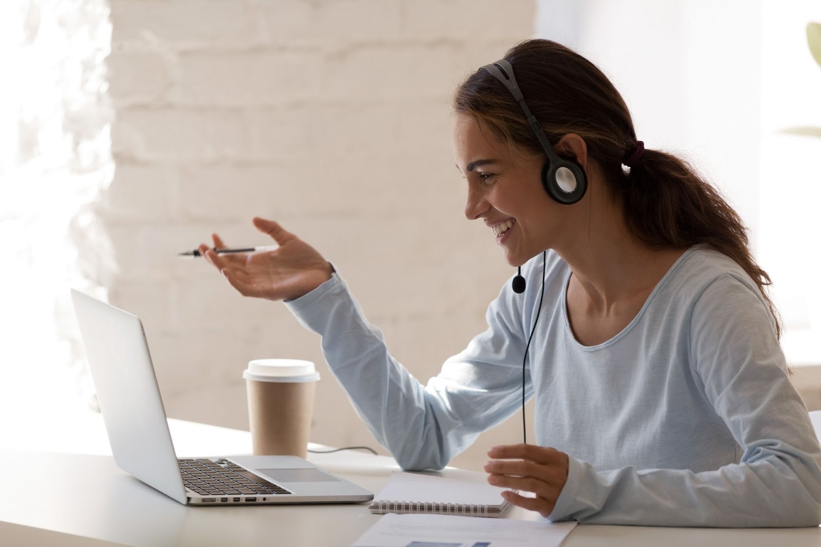 A smiling woman undergoing virtual medical aesthetics training
