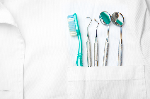 CLose up of a dentist’s coat with tools in their pocket