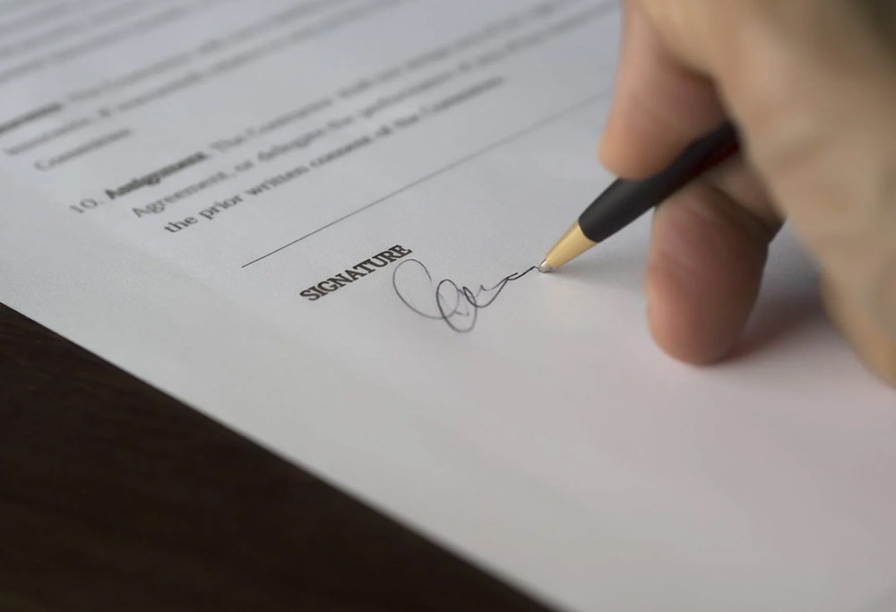 A client signing a medical consent form before undergoing an aesthetic procedure