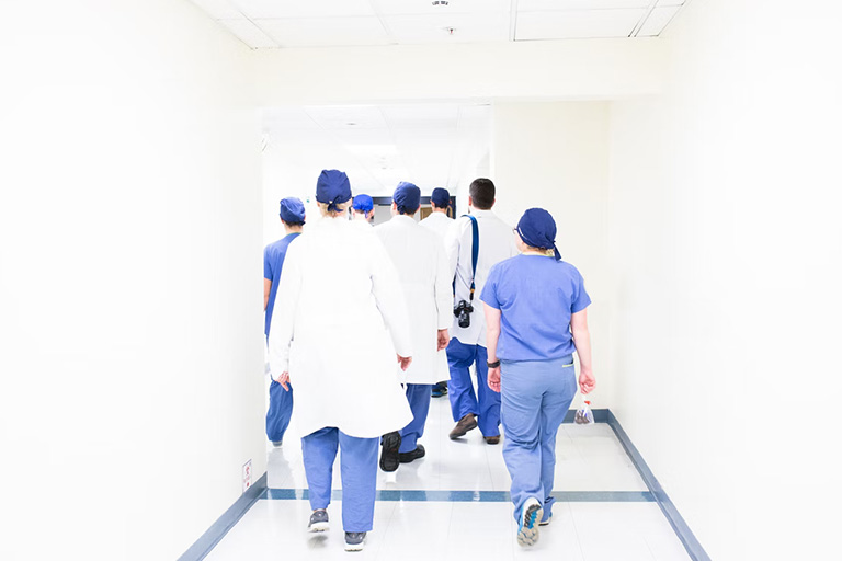 A small group of aesthetic nurses walking toward their classroom to attend lip filler training