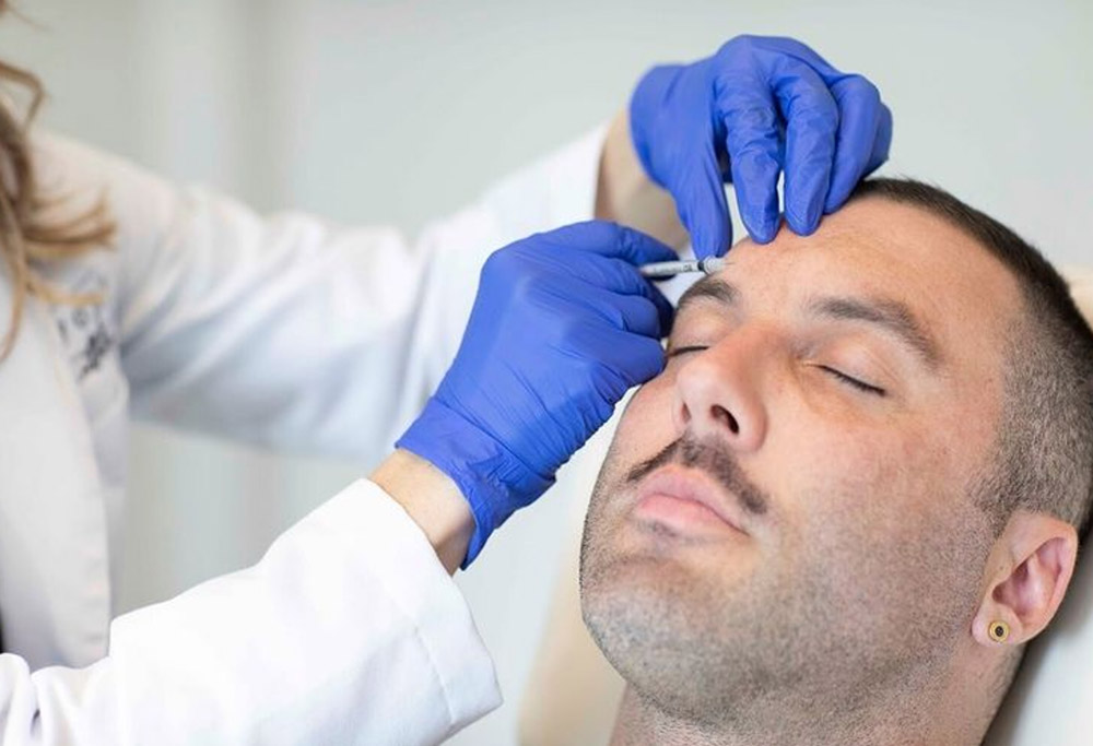 a male patient receiving Botox injections