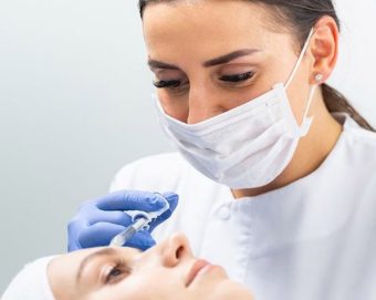 A certified injector giving a female patient a Botox injection