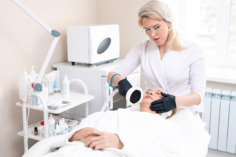An aesthetician performing a facial treatment