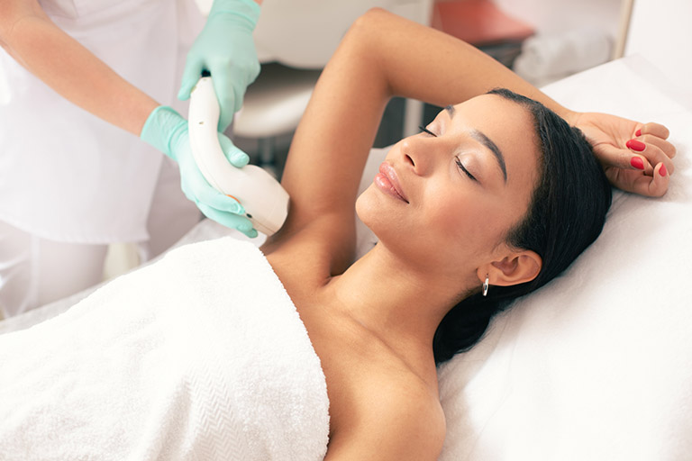 A woman getting laser hair removal treatment