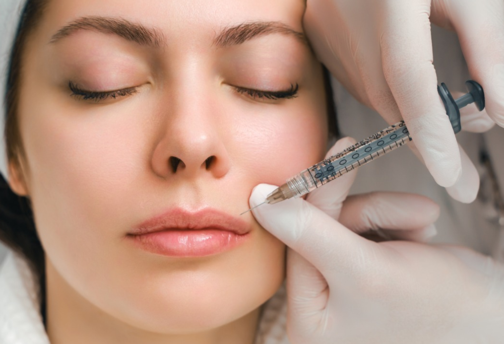 A female patient getting a botox injection above the lips