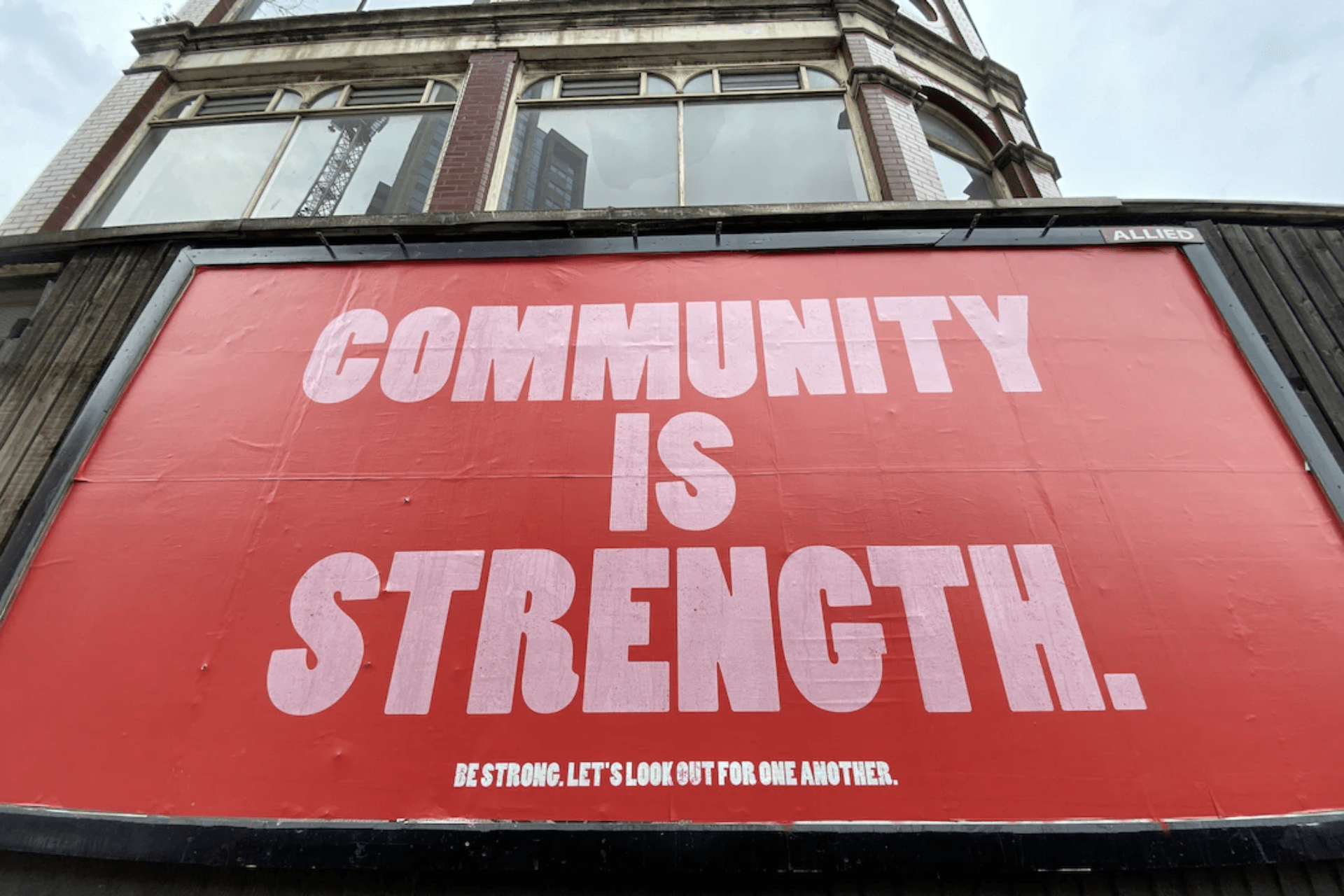 A billboard that says, “Community is strength” 