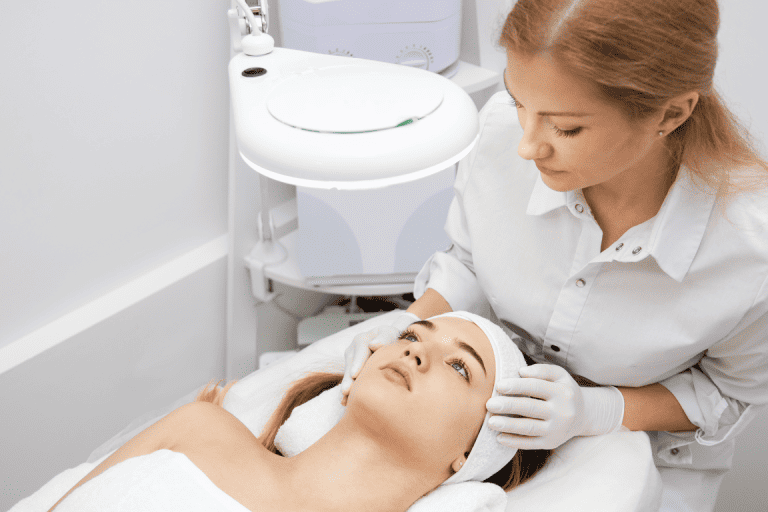 An aesthetician examining a patients face before administering Botox 