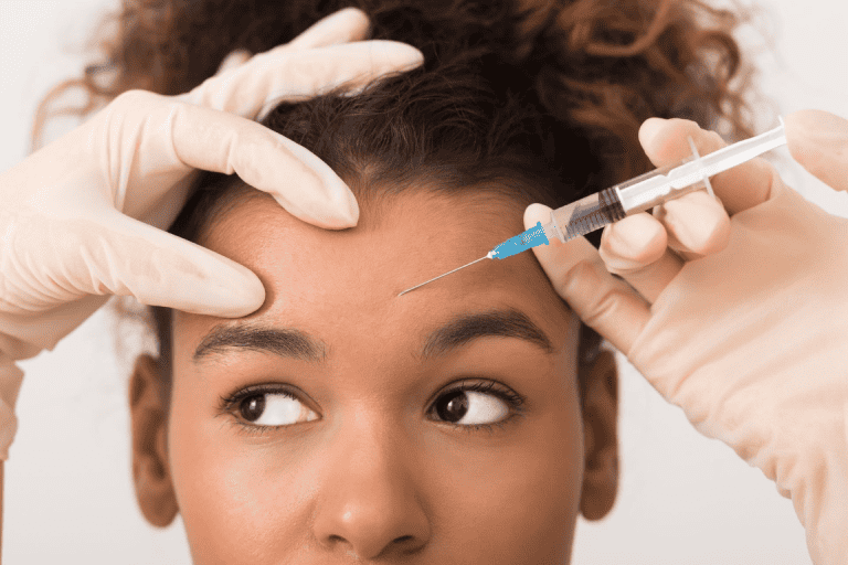 A woman getting Botox on her forehead.