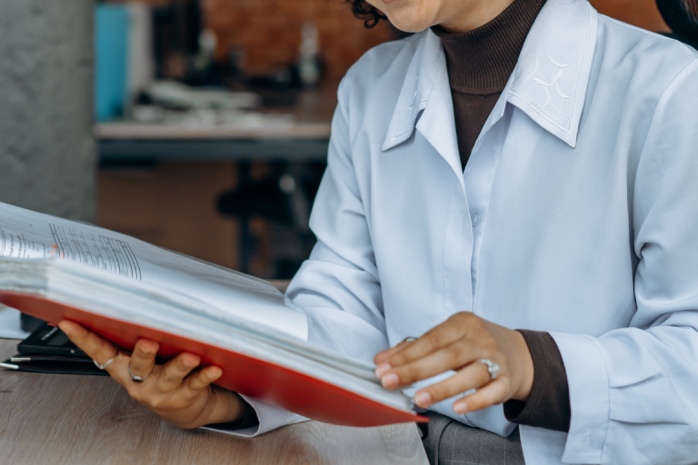  A medical professional looking through a policy binder 