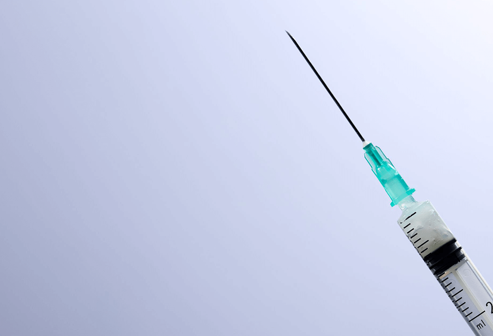 A close-up of a needle with filler