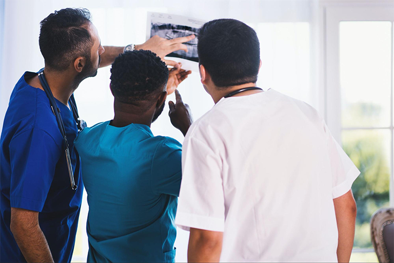  Three doctors examining a lab image.
