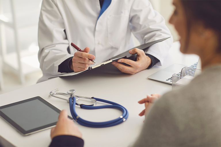 a doctor reviewing paperwork with a patient 