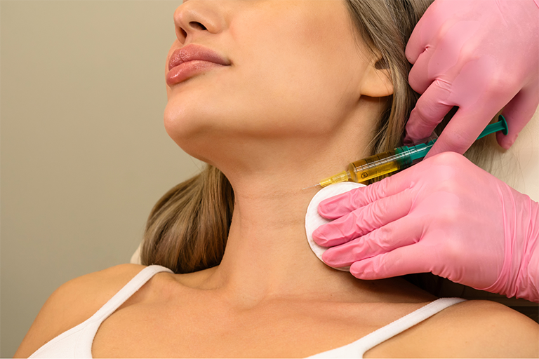 A female patient receiving neck injection from a medical practioner 